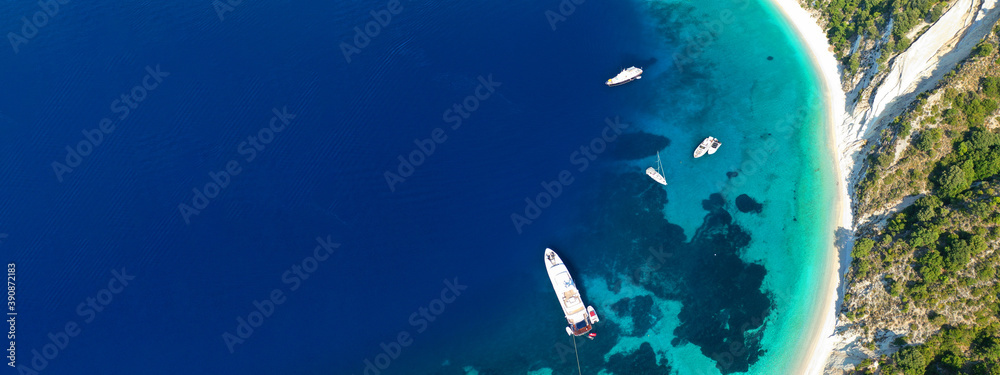Obraz premium Aerial drone top down ultra wide photo of luxury yacht anchored in tropical exotic island turquoise sea