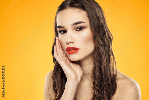 Woman with bare shoulders red cropped lips charm yellow background