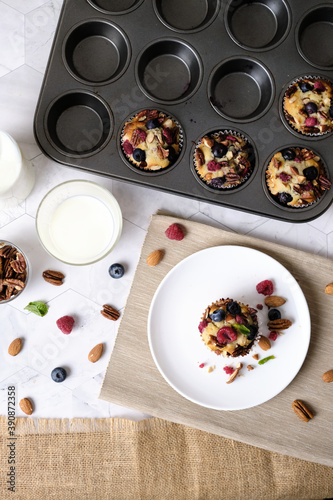 mixed berry low carb Keto Diet muffin with almond and nut. set on cafe table.
