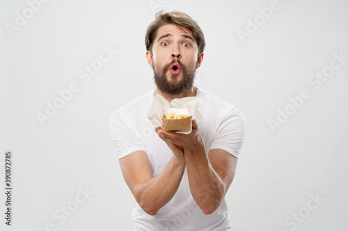 A man holding fast food fries in his hands a diet 