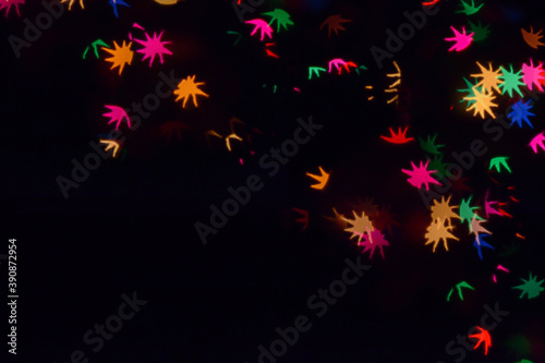 Bokeh lights background. Stars bokeh defocused background. Holiday background. Garland. Defocused blinks. New Year. Bokeh retro style photo.