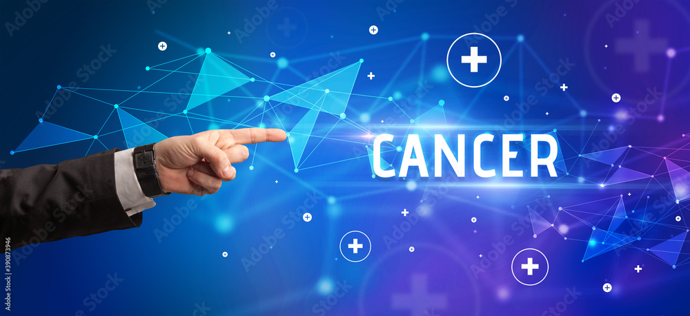 Close-Up of cropped hand pointing at CANCER inscription, medical concept Close-Up of cropped hand pointing at CANCER inscription, medical concept