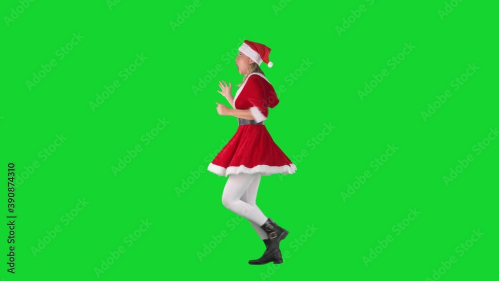 Side view of funny panicking Santa girl in costume running late for Christmas. Full body length on chroma green screen. Side view of funny panicking Santa girl in costume running late for Christmas. Full body length on chroma green screen.