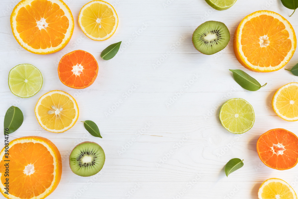 Lemons, lime, orange and grapefruit tangerines and kiwi cut into circles on a white background with space for text. Poster, banner, article. Lemons, lime, orange and grapefruit tangerines and kiwi cut into circles on a white background with space for text. Poster, banner, article.