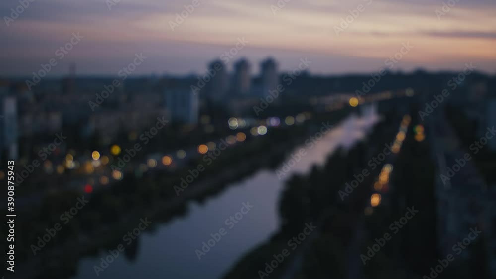 Blurred lights of evening traffic in big city with river Blurred lights of evening traffic in big city with river