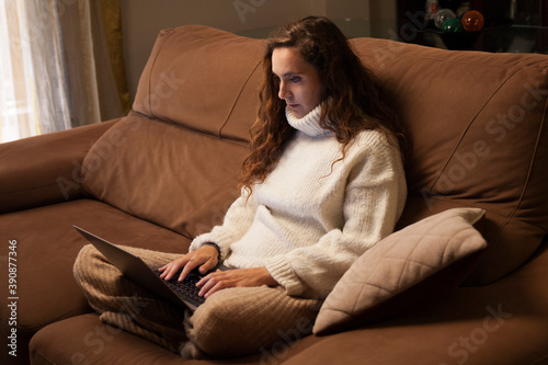 Girl with a computer working from home, in a confy outfit photo