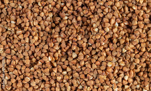 Organic uncooked buckwheat grain pattern background