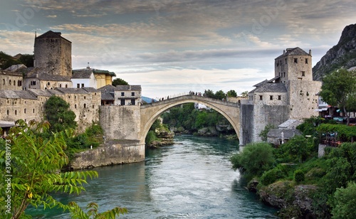 View on Mostar city with old bridge (Stari Most) over the Neretva river and other white stone buildings in Bosnia and Herzegovina.