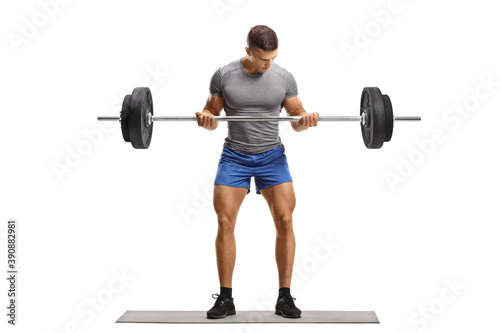 Full length portrait of a fit young man lifting heavy weights