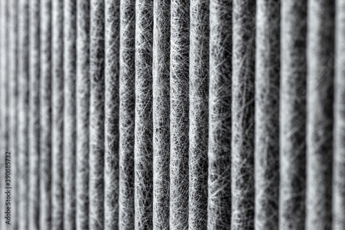 A macro shot of the surface rectangular, carbon cabin filter. Can be used as background, visible fibers arranged in vertical lines.