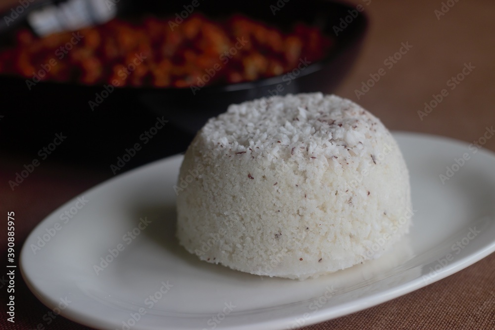 Steamed rice cake with layers of freshly grated coconut in between, a