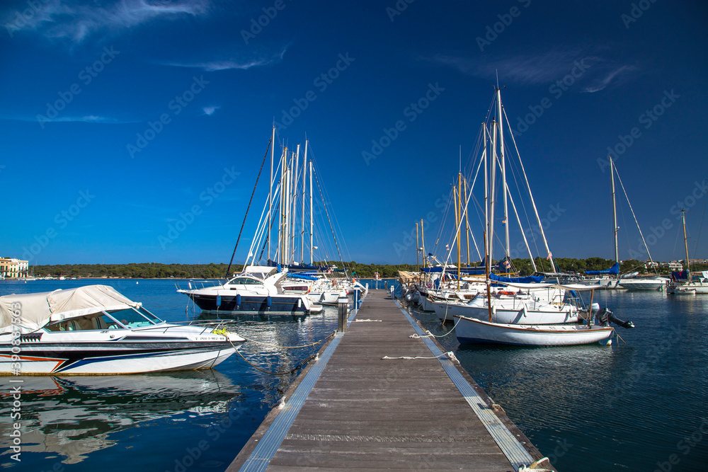 Sailing boats moored at wooden pier with perfect blue sky, Mallorca