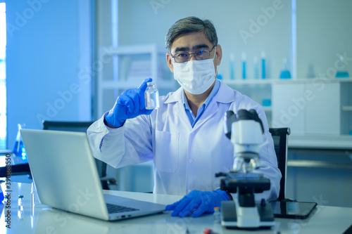 Scientist holding liquid chemical tube in laboratory  Science and technology healthcare concept