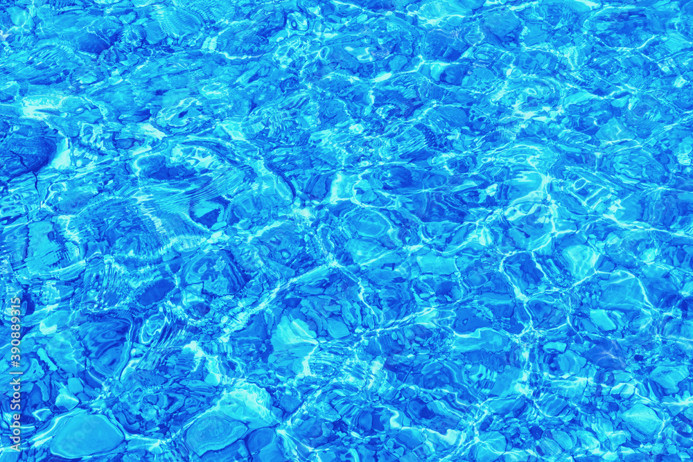 Abstract natural texture. Shallow water, stone beach. Blue color toning