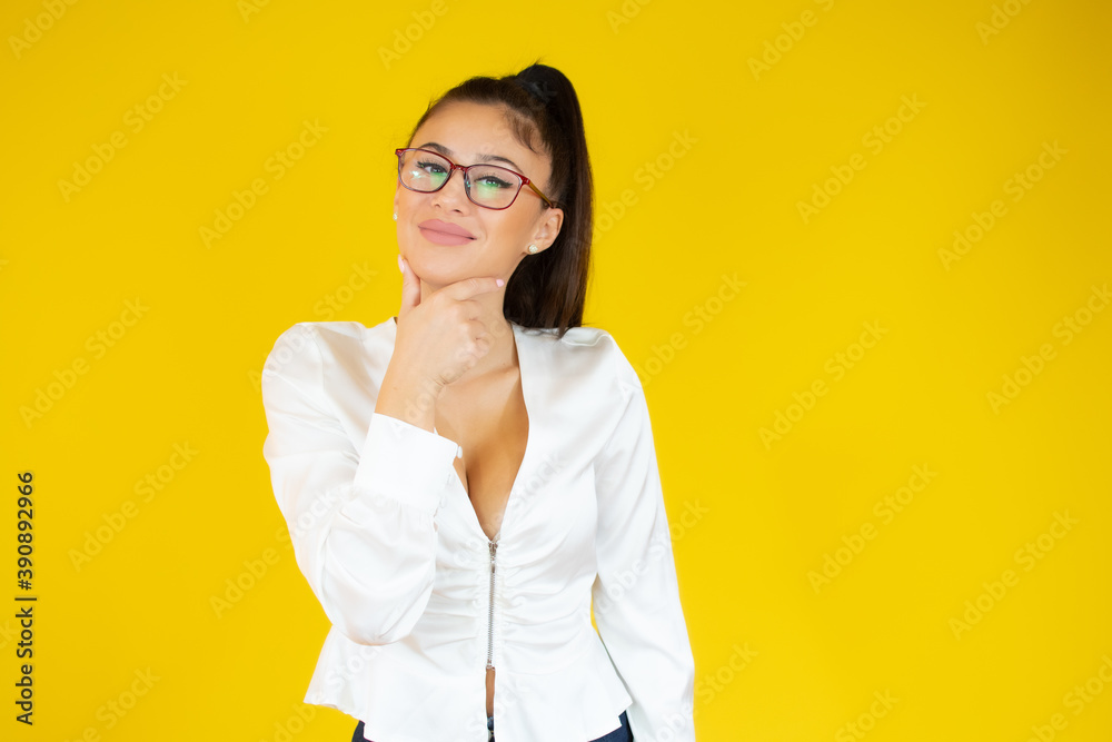 Young beautiful businesswoman wearing elegant shirt standing over yellow background clueless and confused, no idea and doubtful face.