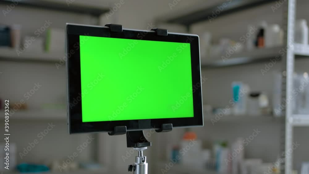 Dolly in close-up green screen shot of digital pad indoor of pharmacy with shelfs full of medicines. Track and replace display for Your content on tablet PC. Dolly in close-up green screen shot of digital pad indoor of pharmacy with shelfs full of medicines. Track and replace display for Your content on tablet PC.
