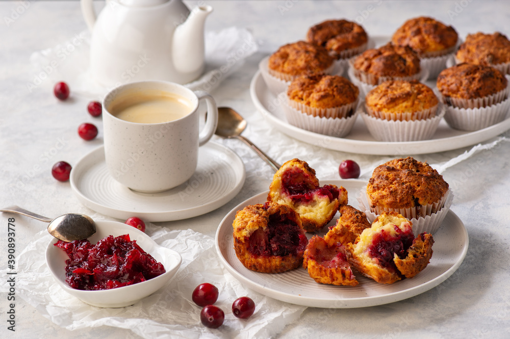 Homemade muffins with cranberry filling, on light background. Homemade muffins with cranberry filling, on light background.