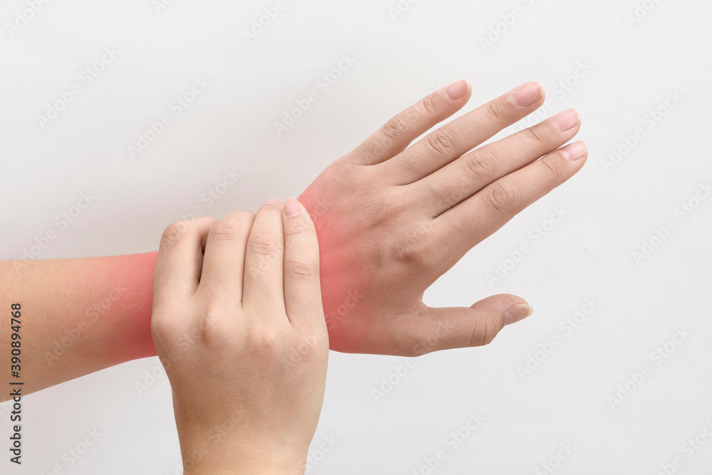 pain in wrist. close-up of female hand with red dot on white background pain in wrist. close-up of female hand with red dot on white background