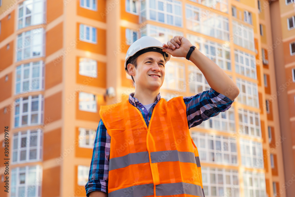 Portrait of young worker with security helmet at construction building Portrait of young worker with security helmet at construction building