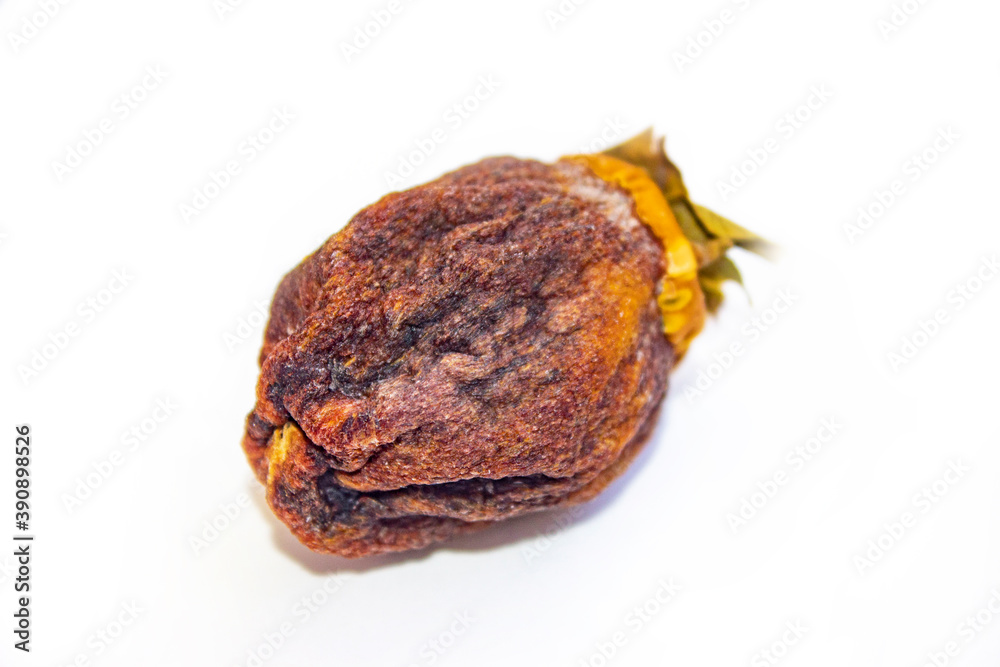 Chocolate persimmon, kinglet. Large dried fruit whole. Brown-orange with deep grooves. Healthy food and snacks. Light background. Chocolate persimmon, kinglet. Large dried fruit whole. Brown-orange with deep grooves. Healthy food and snacks. Light background.