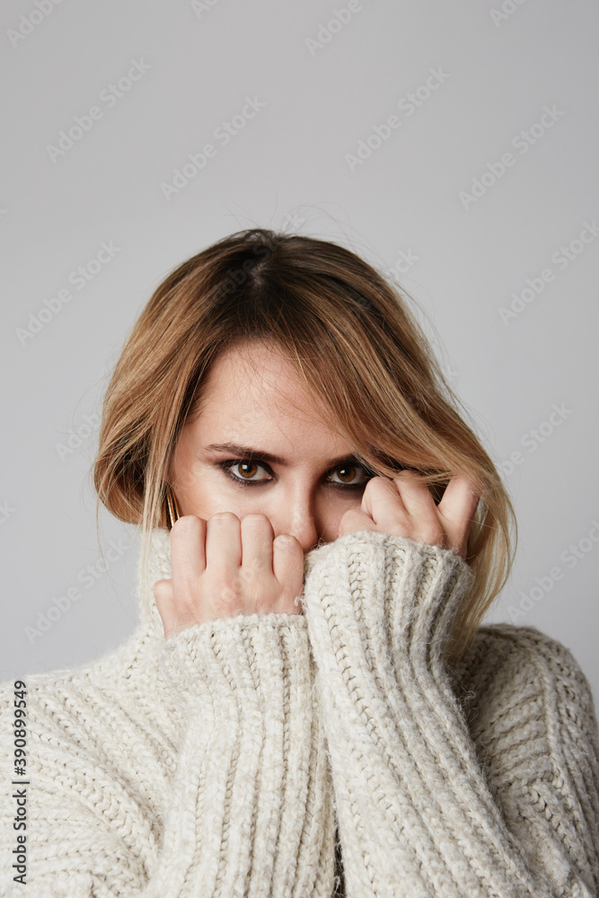 Vertical portrait of young woman wearing warm sweater. Winter concept. Vertical portrait of young woman wearing warm sweater. Winter concept.