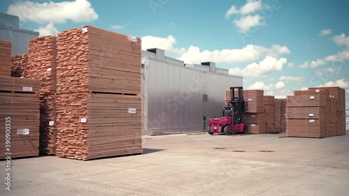 Forklift Operator Handling Wooden Pallets In Warehouse