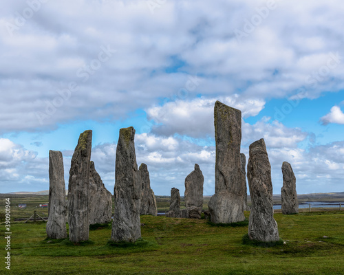 Calanais standing stones on the Isle of Lewis in Scotland, United Kingdom on a Cloudy day with a Blue Sky