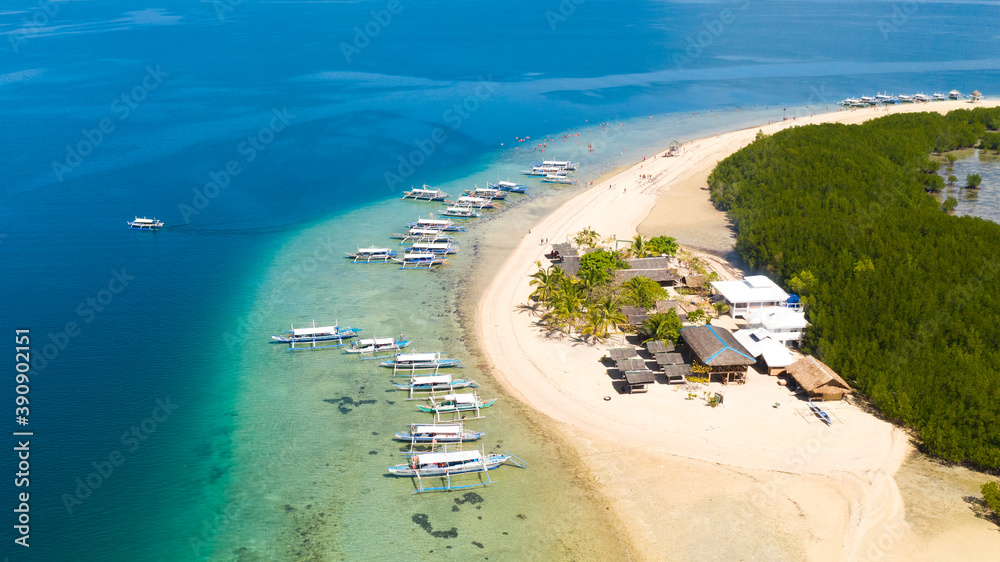 Island hopping Tour at Honda Bay, Palawan. An island of white sand with mangroves. Atoll with a white island, view from above.