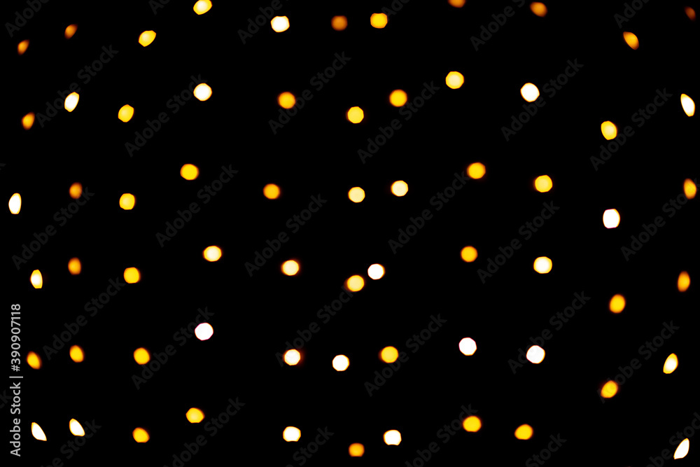 golden colored bokeh on black background, christmas lights