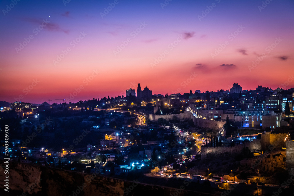panorama of jerusalem from 
Jewish cemetery on the Olive Hill with a mosque dome on the rock in the light of the setting sun