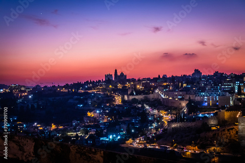 panorama of jerusalem from Jewish cemetery on the Olive Hill with a mosque dome on the rock in the light of the setting sun