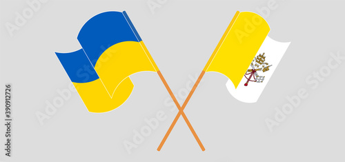 Crossed and waving flags of Vatican and the Ukraine