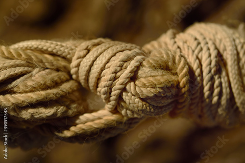 Close up of several hemp strings tied together in a very intricate knot