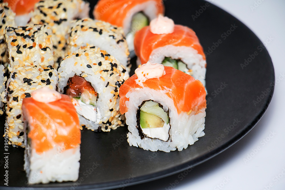 Different kind of rolls and sushi on black plate isolated over white background
Different kind of rolls and sushi on black plate isolated over white background