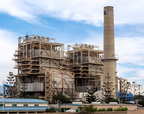 Iconic smokestacks mark the old 1950's era electric power plant, which soon will be replaced by a lower-profile, natural gas-fired power plant on Pacific Coast Highway in Huntington Beach, California.