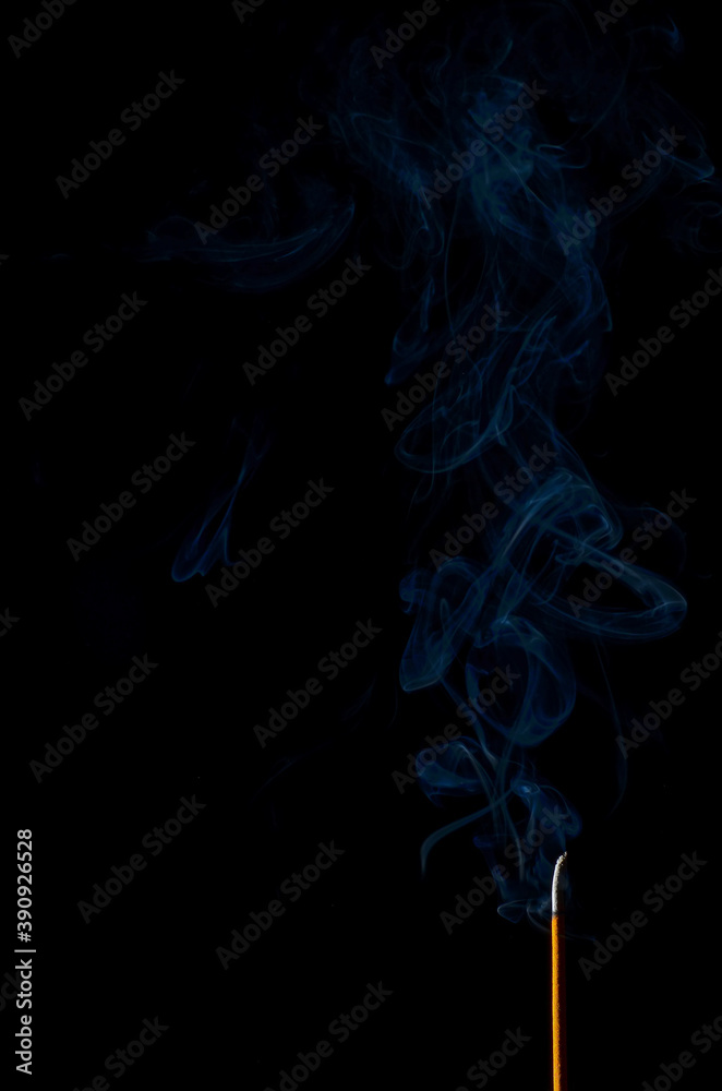 incense and smoke close-up on a black background