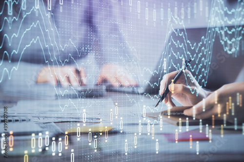 Multi exposure of woman hands typing on computer and forex chart hologram drawing. Stock market analysis concept.