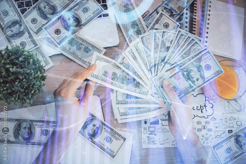 Multi exposure of financial graph drawing hologram and USA dollars bills and man hands. Analysis concept. Multi exposure of financial graph drawing hologram and USA dollars bills and man hands. Analysis concept.