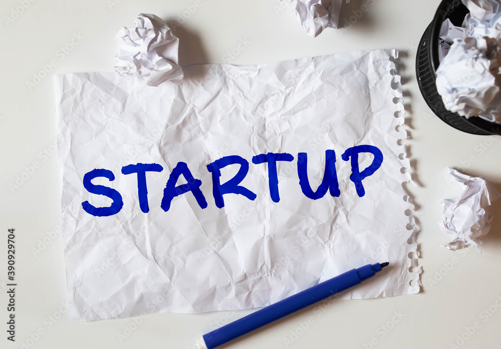 Human hand writing word STARTUP, business concept Human hand writing word STARTUP, business concept