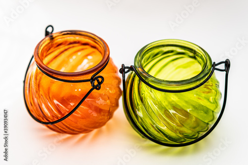 Closeup shot of orange and green lantern jars isolated on a white background