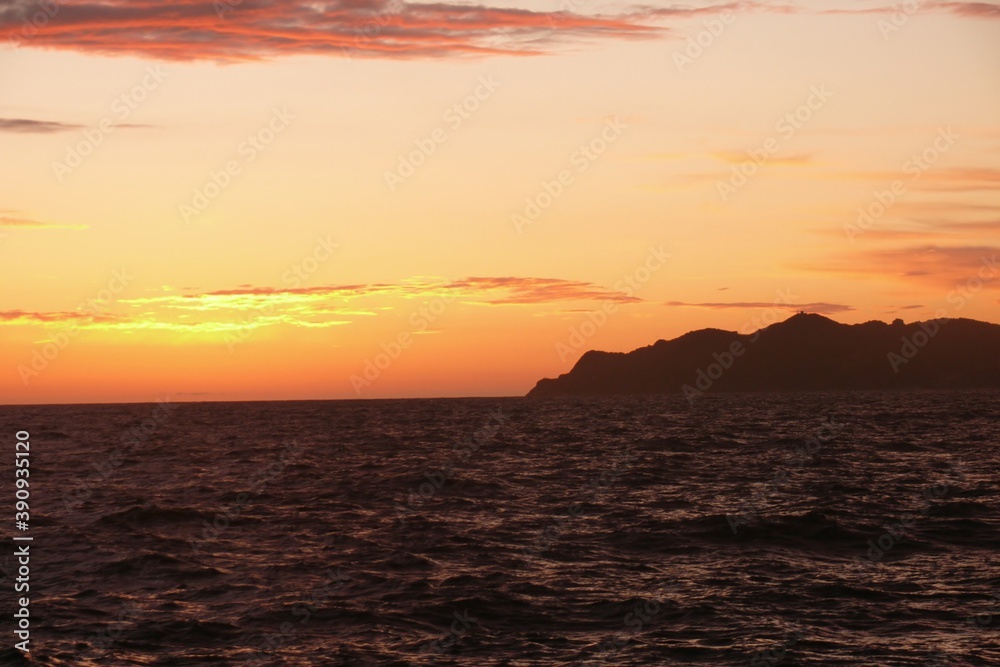 Sunset over the Meditarienian sea island form the deck of a tallship