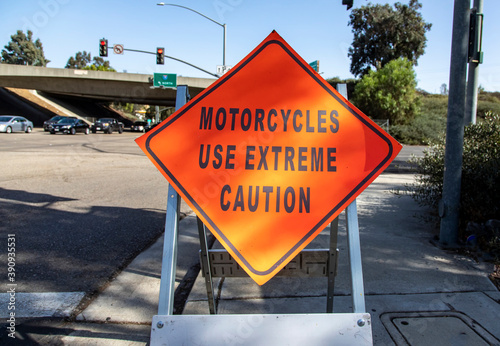 A diamond shaped road sign advising motorcyle riders to use extreme caution