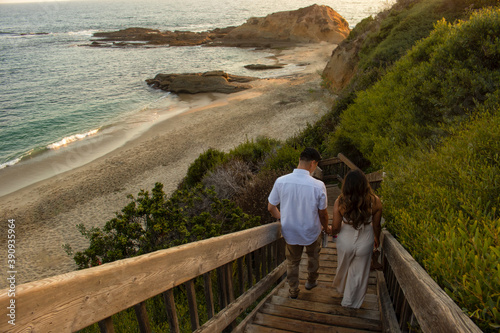 couple walking down stairs beach sunset photo