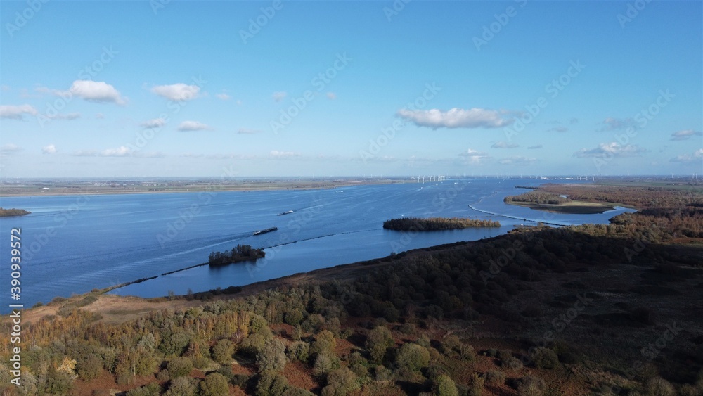 Nature view with wind turbines farm. Over water seen from the air.