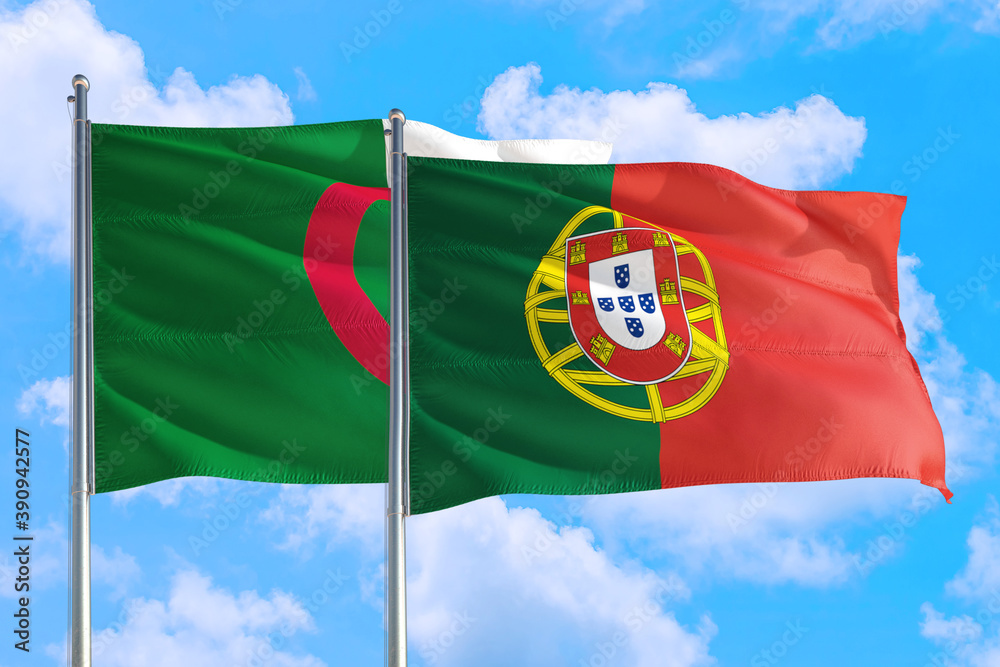 Portugal and Algeria national flag waving in the windy deep blue sky. Diplomacy and international relations concept. Portugal and Algeria national flag waving in the windy deep blue sky. Diplomacy and international relations concept.