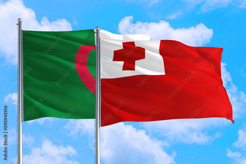 Tonga and Algeria national flag waving in the windy deep blue sky. Diplomacy and international relations concept.