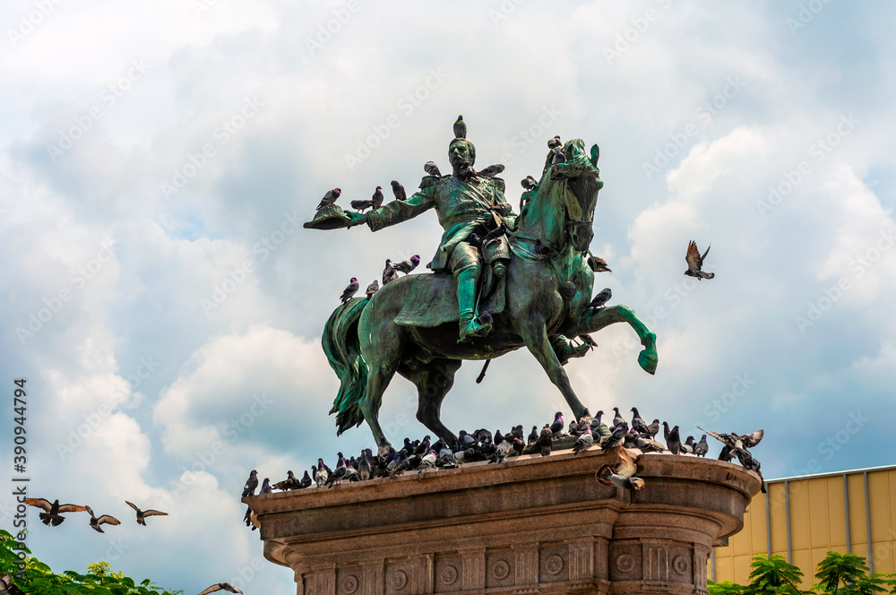 The statue of Gerardo Barrios surrounded by pigeons located in the historical downtown district of San Salvador, El Salvador. 
