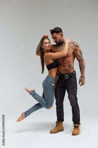 Woman hugging muscular man from behind