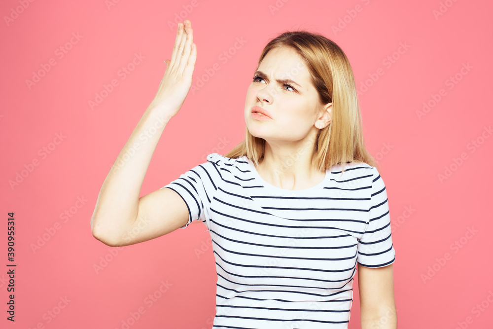 Blonde striped t-shirt emotion gesture hands displeased facial expression pink background Blonde striped t-shirt emotion gesture hands displeased facial expression pink background