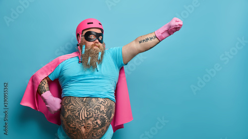 Fotografiet Self confident serious bearded man ready to help people wears superhero costume